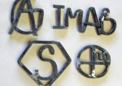 Brands designed by Rancho Santa Fe Elementary (Avondale, Arizona) students and recreated in metal by Phoenix sculptor Kevin Caron for the sculpture Bronco Brand Birch.