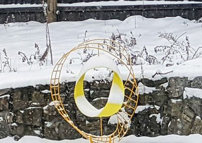 Echo, a contemporary yellow sculpture, in the snow - Kevin Caron