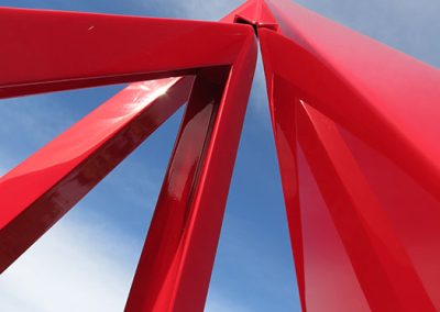 Closeup of Fuego, a contemporary red kinetic sculpture - Kevin Caron