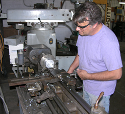 Sculptor Kevin Caron using his metal lathe