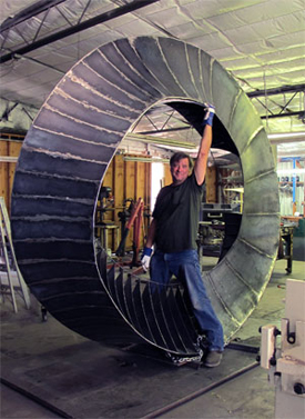 Artist Kevin Caron inside his fine art sculpture Wherever You Go, There You Are