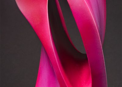 A closeup of Eyelet, a fine art sculpture in red tones - Kevin Caron