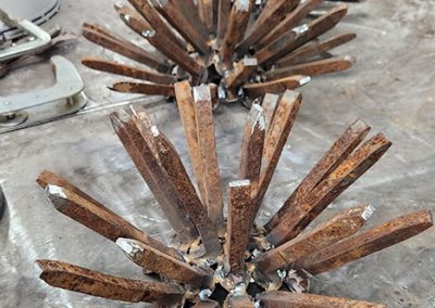 Three blooms for a desert plant made of recycled railroad spikes under way - Kevin Caron