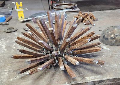 One of the blooms for a desert plant made of recycled railroad spikes under way - Kevin Caron